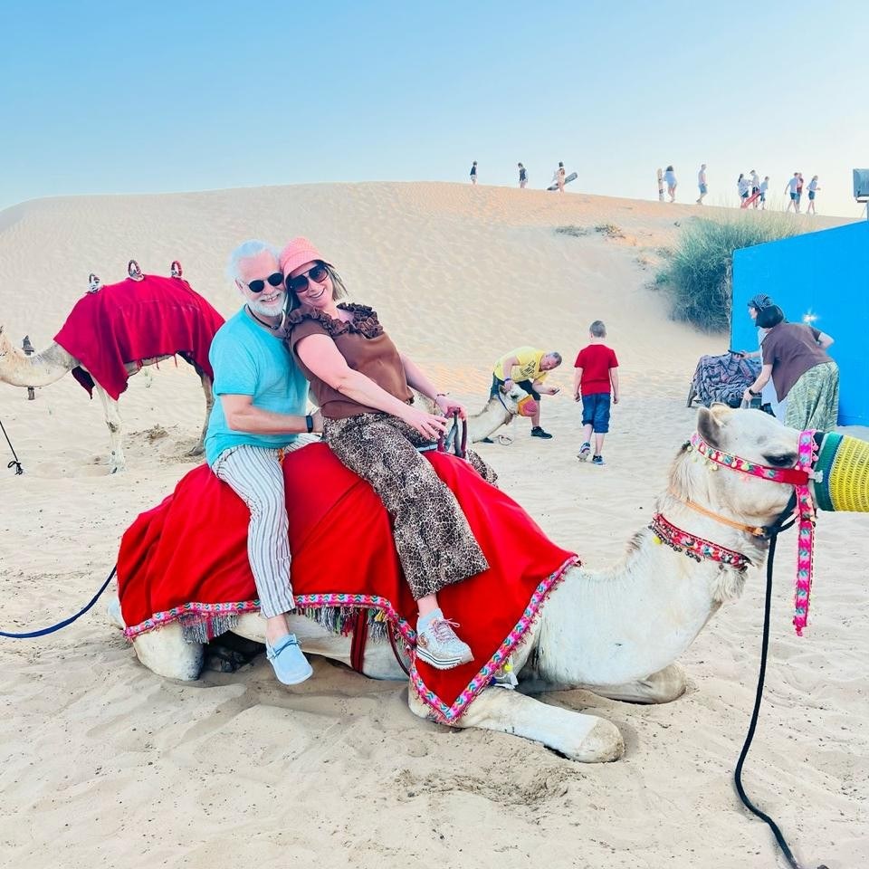 Guests enjoying a camel ride in the Dubai desert