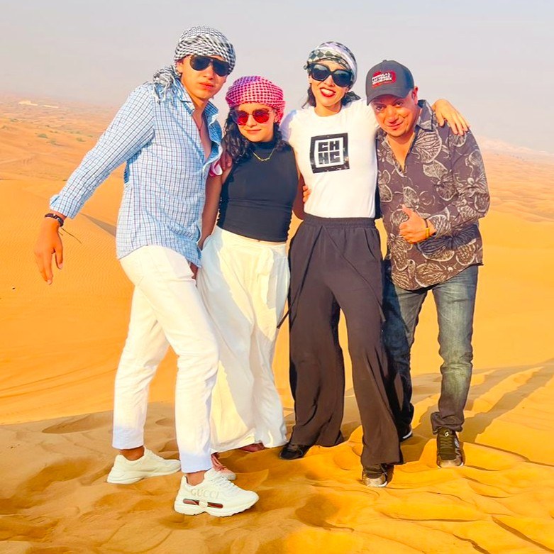 Group of friends enjoying the red dunes of Dubai