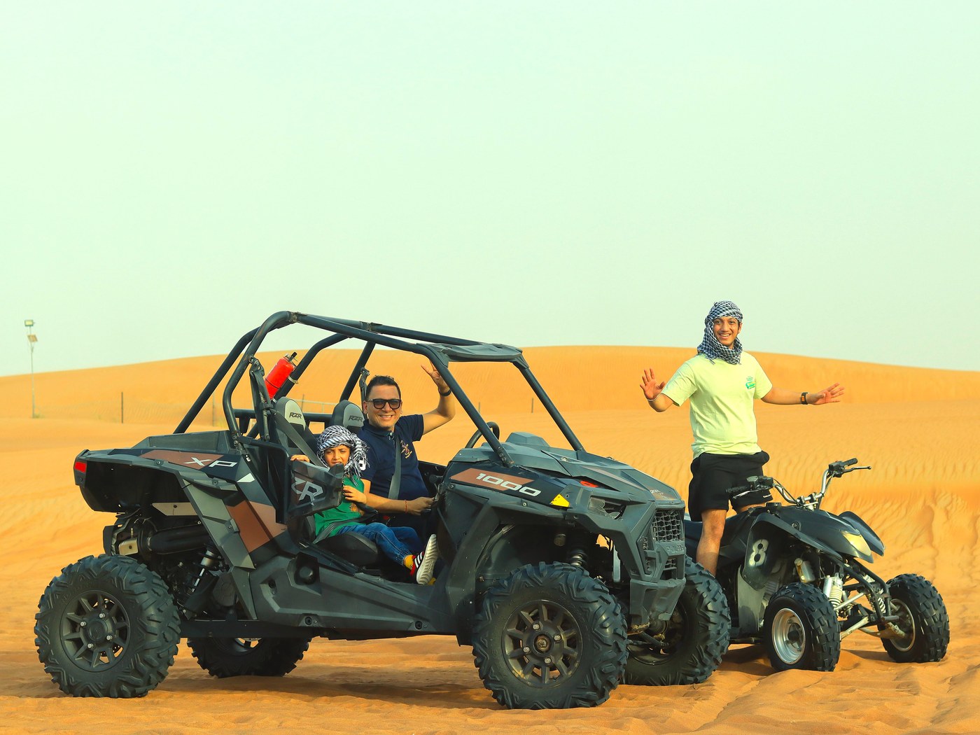 Guests riding a dune buggy as part of the Desert Safari plus Quad Bike package