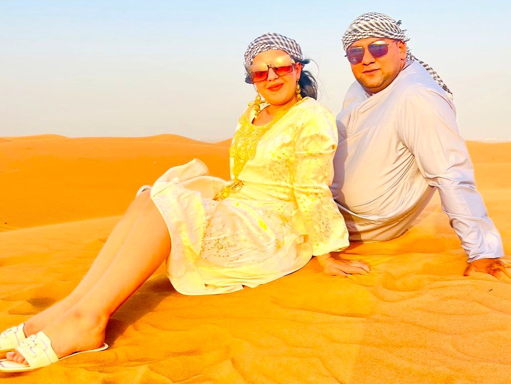 Guests in traditional dress enjoying the Standard Desert Safari in Dubai