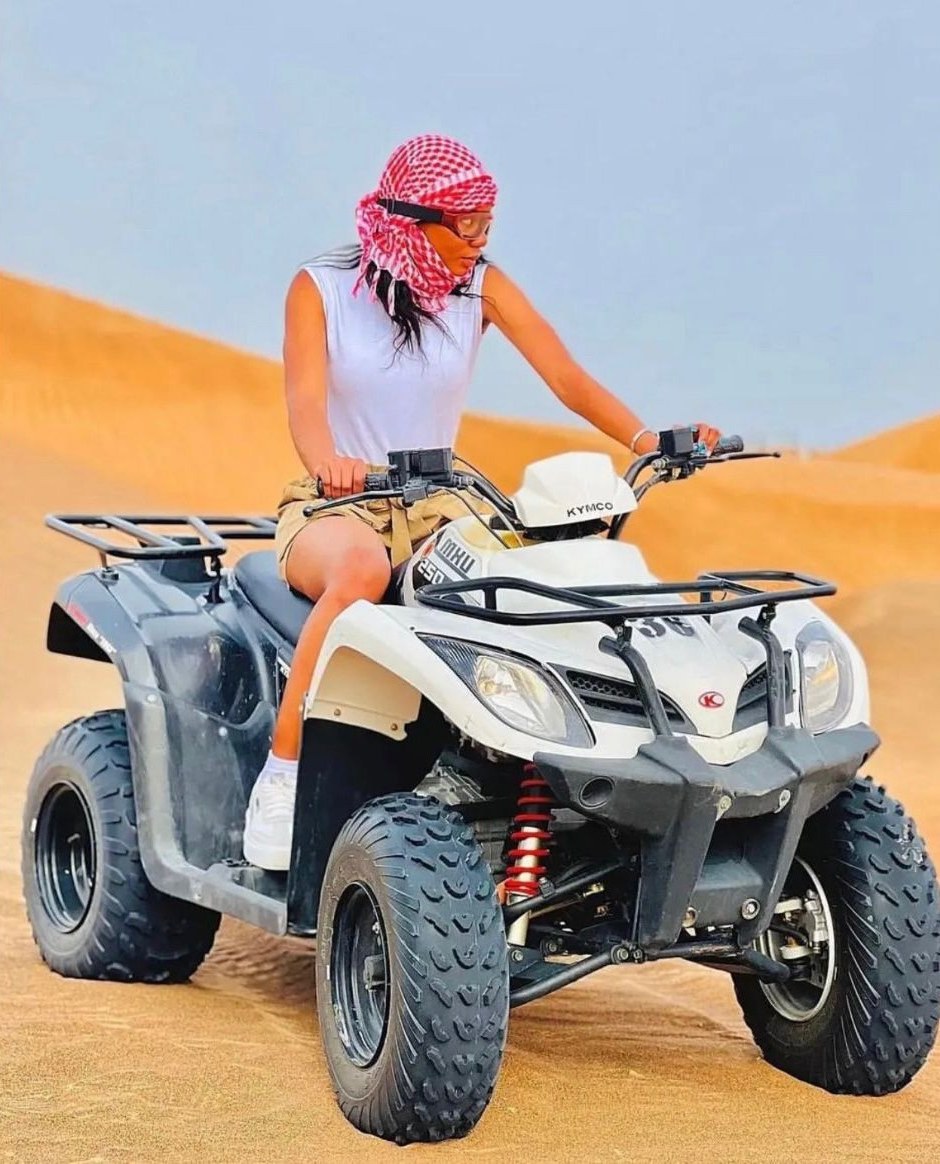 Guest riding a quad bike on the dunes near Dubai