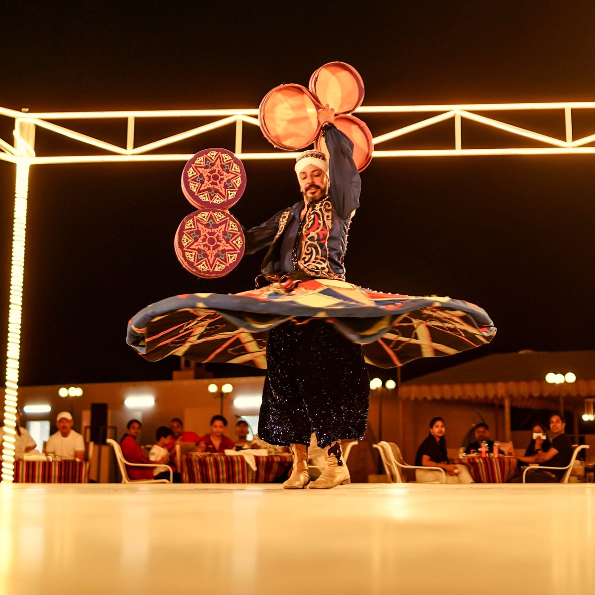 Tanoura dancer performing at a Dubai desert safari camp
